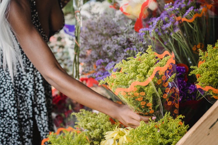 Woman Picking Flowers At Market Stall