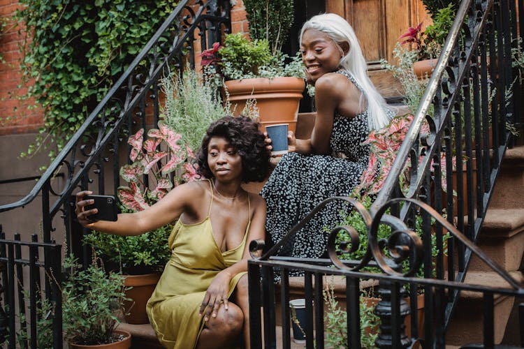 Women Taking Photos On Stairs