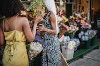 Woman in Yellow Sleeveless Dress Holding Bouquet of Flowers