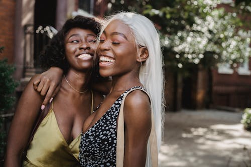 Free Two Women Friends Smiling and Hugging Each Other Stock Photo