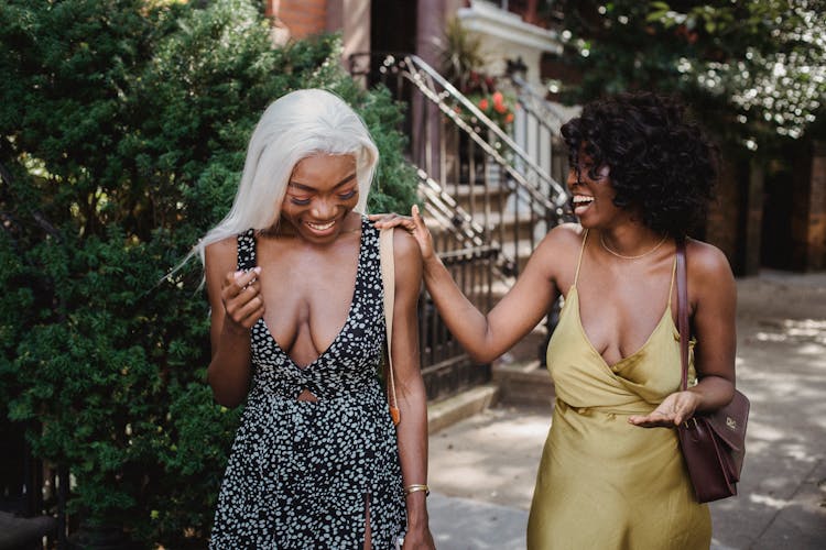 Laughing Women Walking On Sidewalk