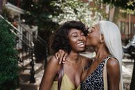 Woman in Black and White Polka Dot Tank Top Kissing Woman in Black and White Polka