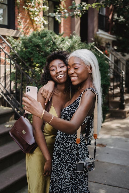 Free Two Women Standing on Sidewalk Taking Selfie Stock Photo