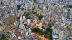 Aerial view of contemporary city residential district with towers near green parks and roads