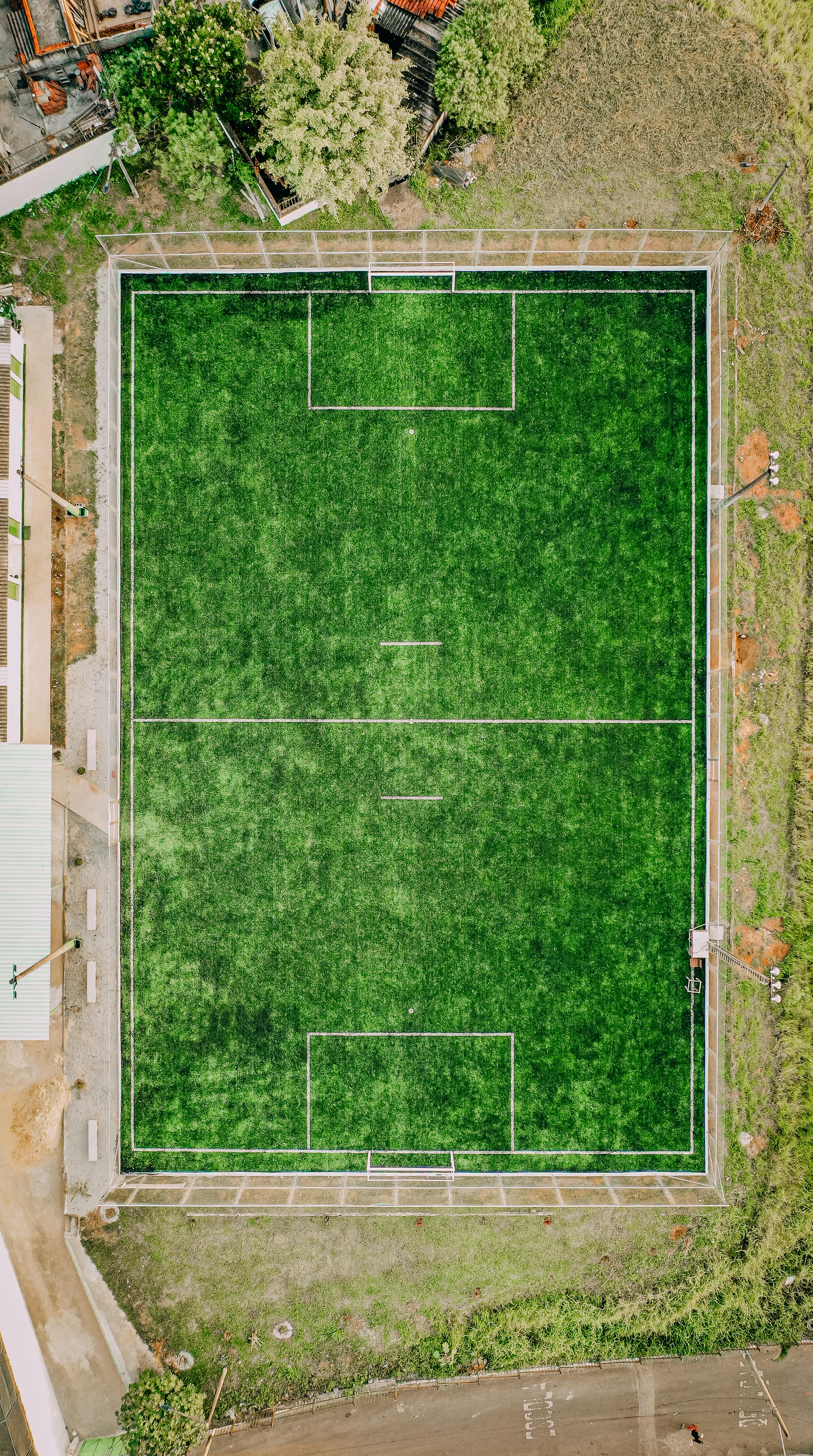 empty sport court surrounded by green grass
