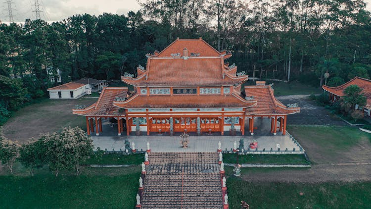 Old Chinese Palace Facade Near Trees In Town