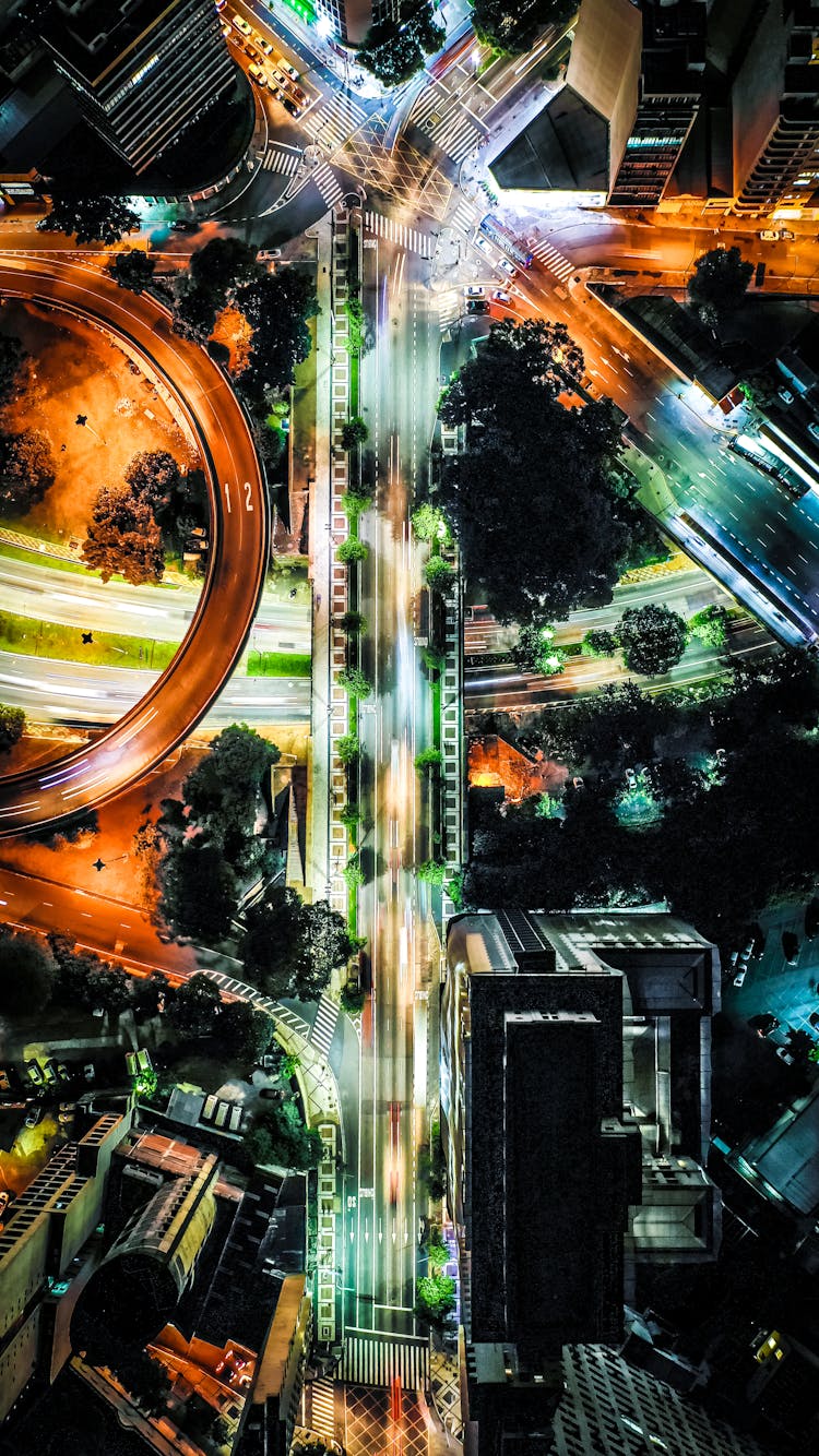 Shiny Road Intersection In City At Night