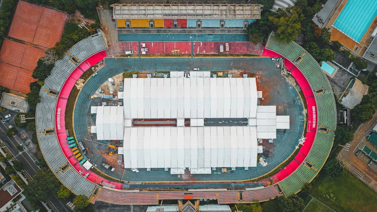 Former Stadium With White Roof And Cars