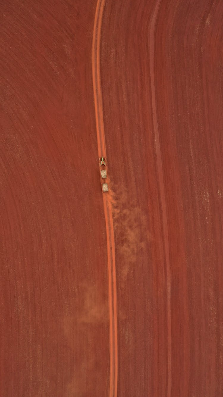 Car With Trailer Driving On Pathway In Desert In Daytime