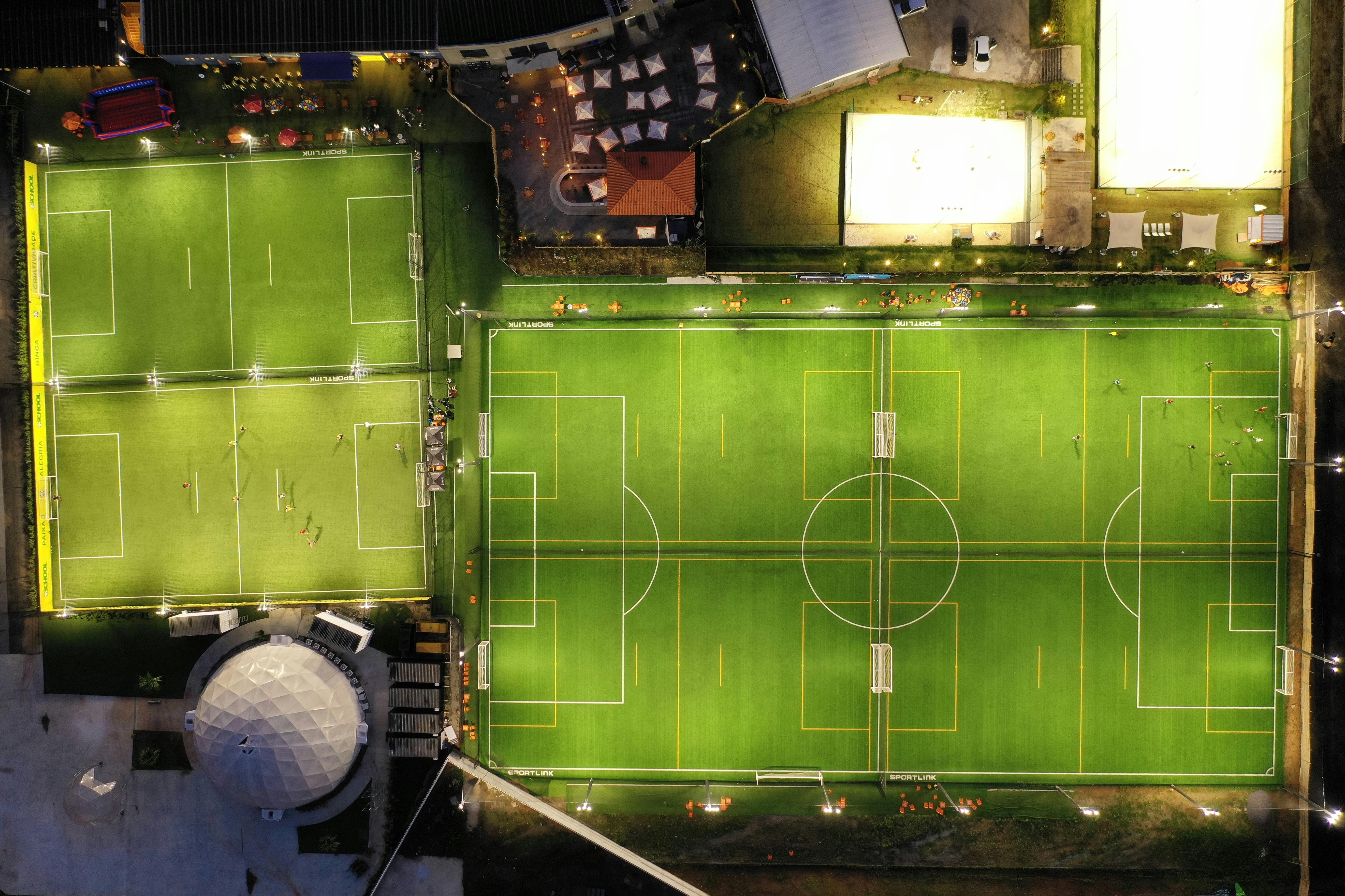 green modern football fields in city