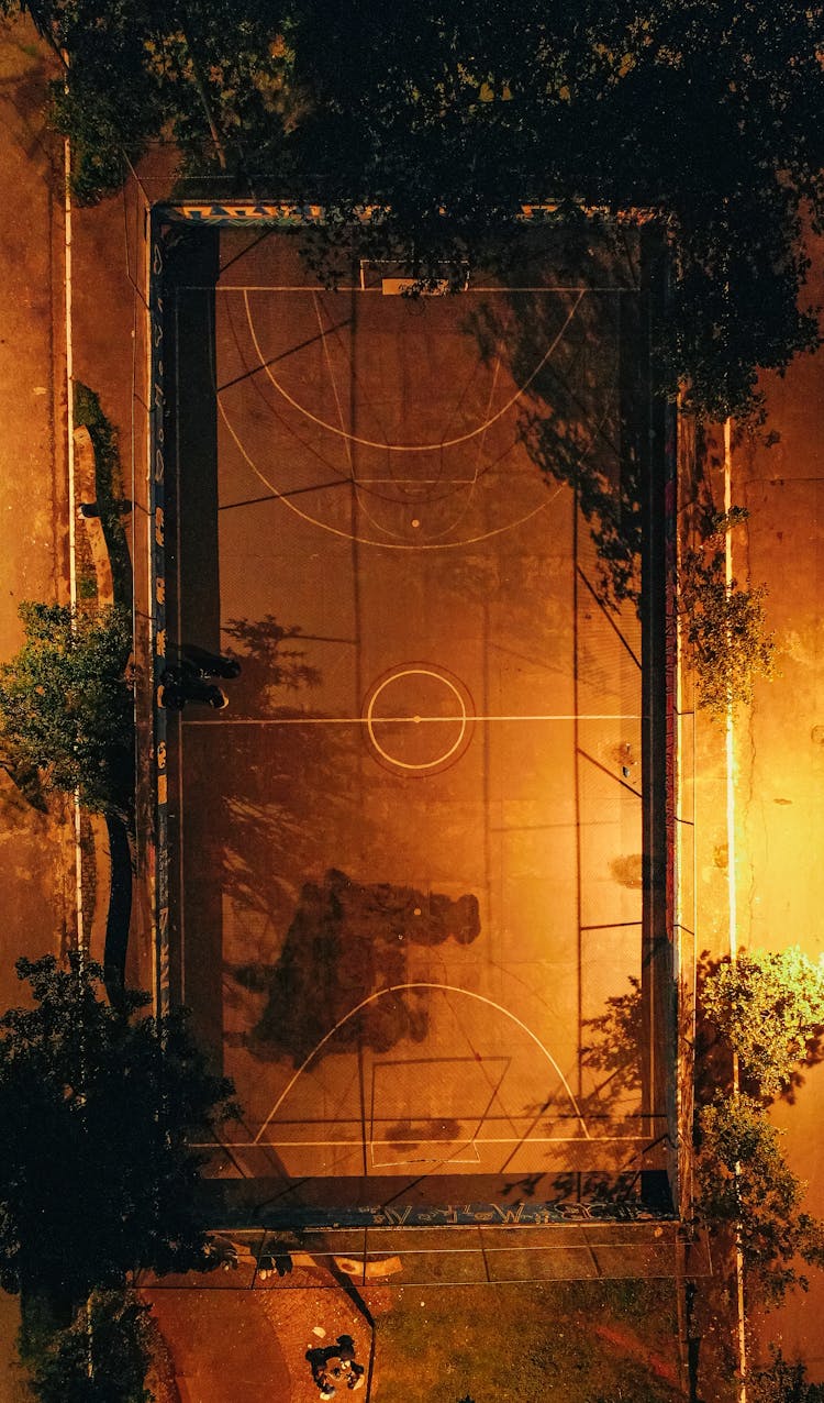 Sports Ground With Basketball Hoop At Night