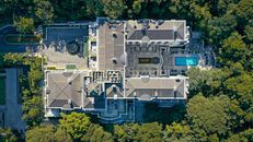 Aerial view of luxury expensive villa with pool located in wild place surrounded by lush trees