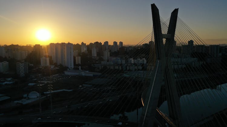 Cable Stayed Bridge Over River At Sunset