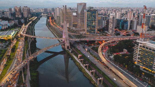 Mast road bridge over river in megapolis