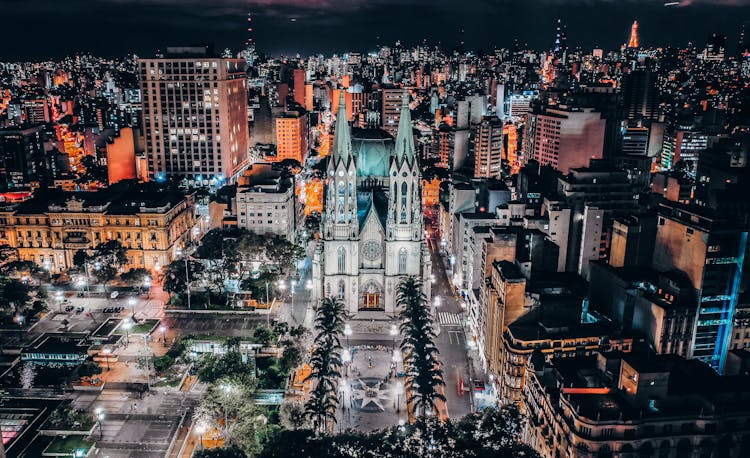 Illuminated Gothic Cathedral In Megapolis At Night