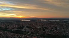 Picturesque cityscape under cloudy sky on sundown