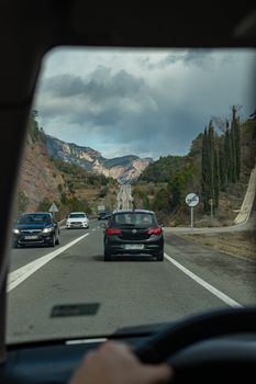 Black Suv on Road Near Green Trees and Mountain