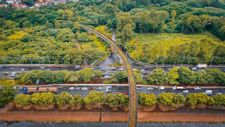 Aerial Busy Road Between Verdant Lush Greenery