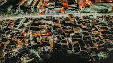 Aerial congested residential area with illuminated houses at night