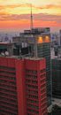 High skyscrapers located in modern megapolis district under colorful sunset sky with clouds at dusk