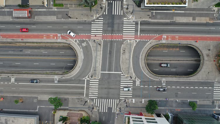 Cars Driving On Large Asphalt Road In Daylight