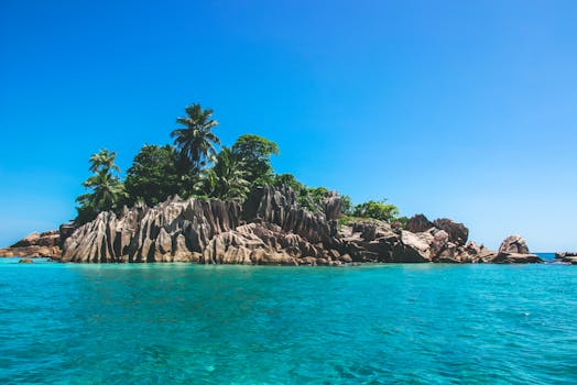 Explore the pristine St. Pierre Island in Seychelles, surrounded by clear turquoise waters and stunning rock formations.