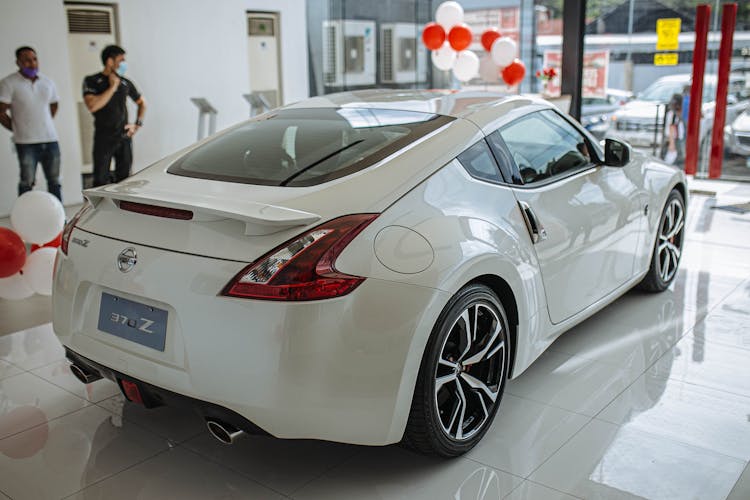 White Luxury Car In Car Dealership Building