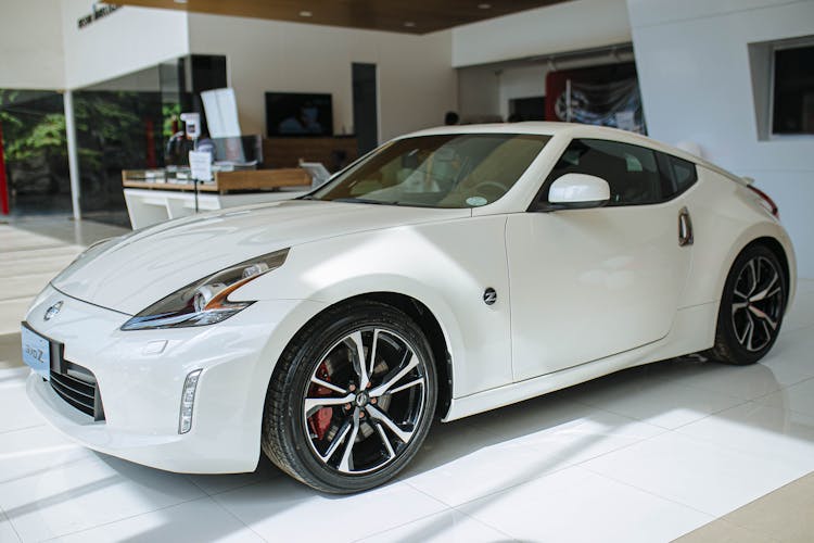 White Luxury Car In Car Dealership Building