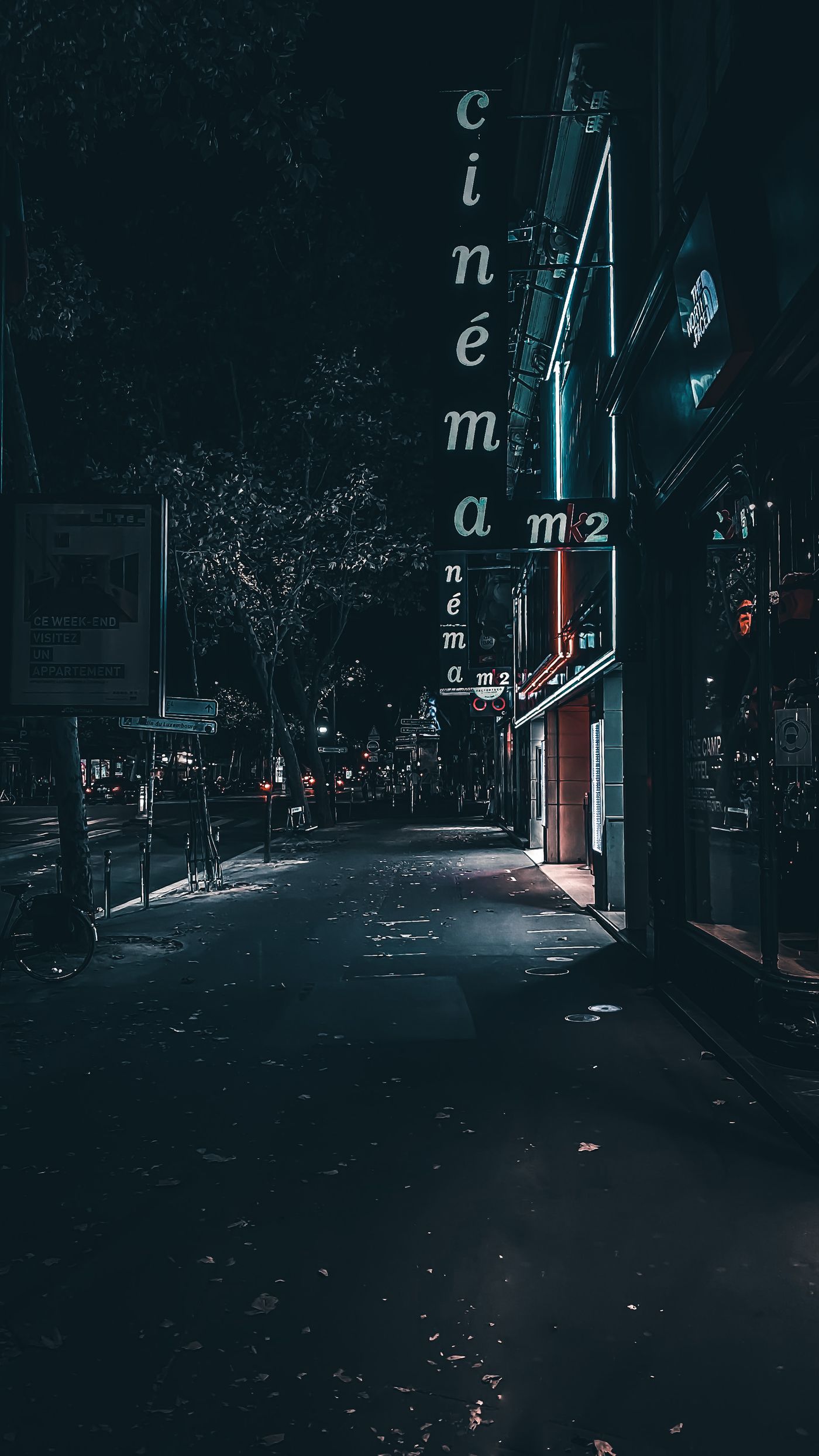 Atmospheric night street with cinema signage — editorial visual accompanying anime review