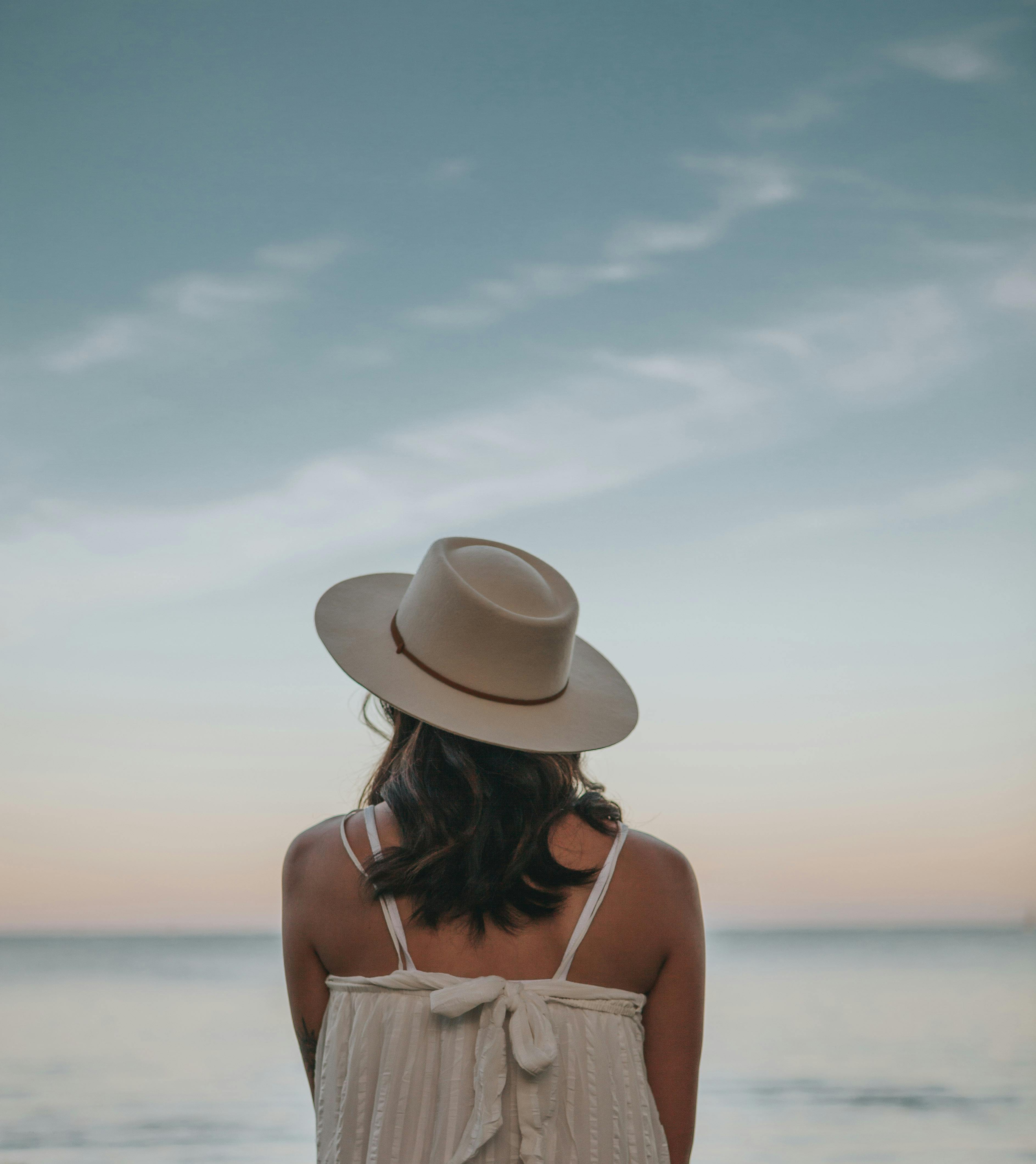 Calm woman resting on seashore in twilight · Free Stock Photo