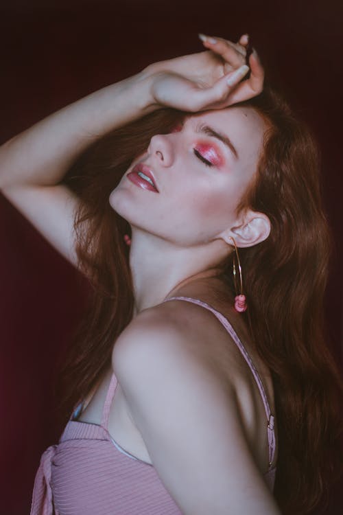 Free side view of attractive lady with bright makeup wearing pink blusher techniques image 1