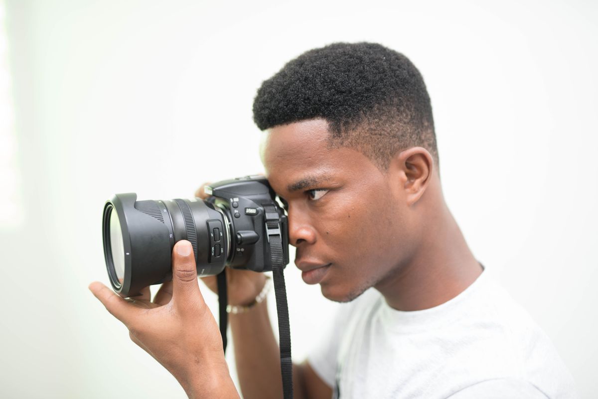 A young man holding a camera