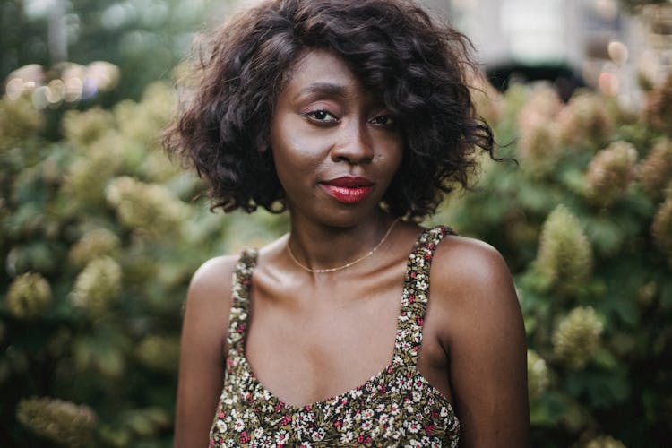 Portrait Of Beautiful Woman With Flowers In Background 