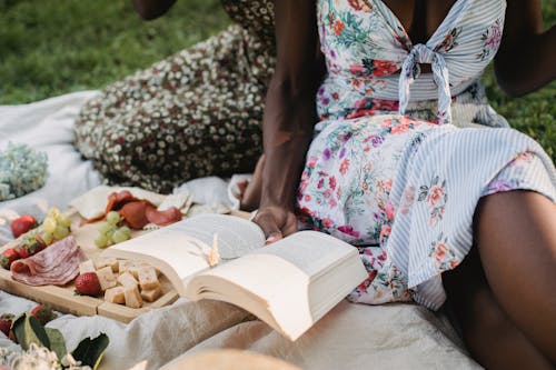 Close-up of Women Reading Book on Picnic