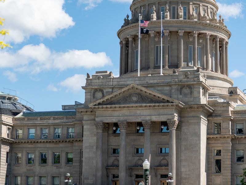Crowd of tourists gathering near historic Idaho State Capitol building with basilica and pillars on sunny summer weather in Boise City - civics and government field trips