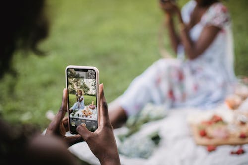 Person Taking Picture of a Woman