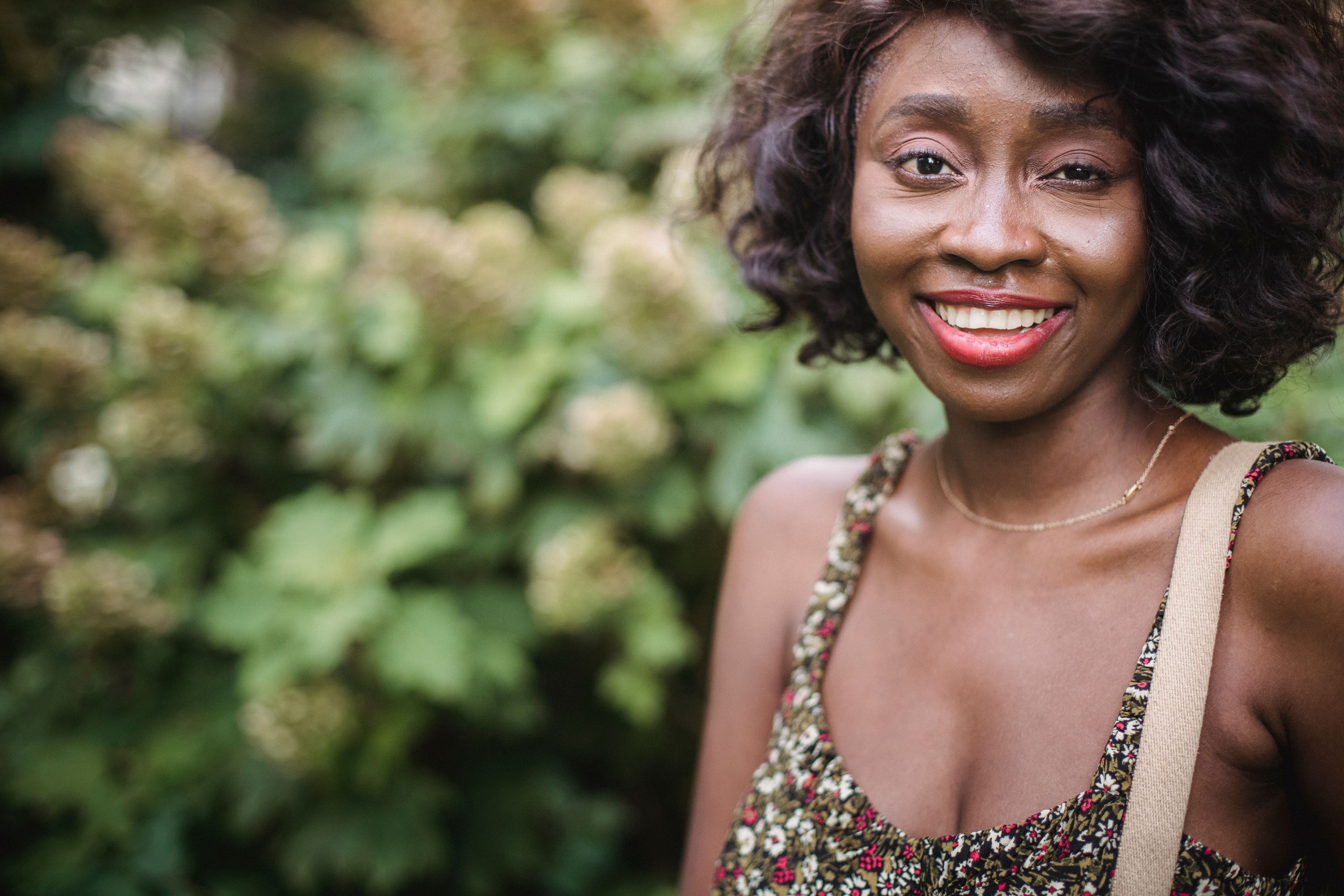 A Smiling Woman Wearing a Floral Top · Free Stock Photo