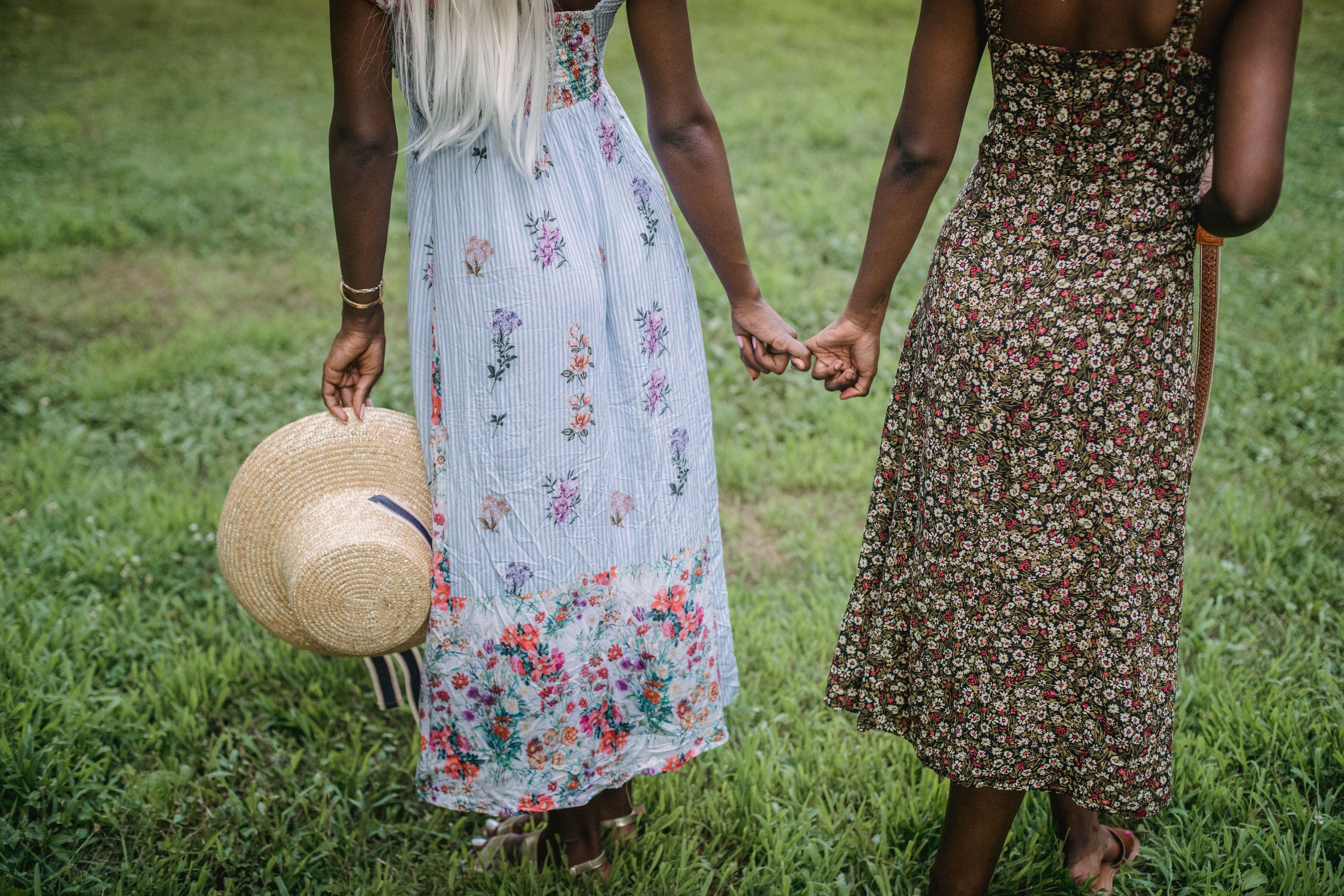 Women Holding Hands While Standing on Grass · Free Stock Photo