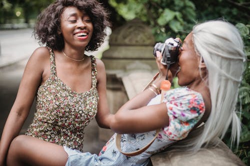 Woman Talking a Picture of her Friend with Floral Dress