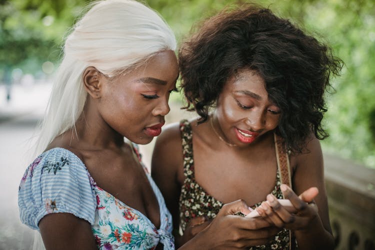 Women Looking At A Smartphone Together