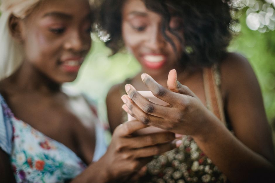 Photo by Ketut Subiyanto on Pexels Two women enjoying a shared moment while looking at a smartphone outdoors. Vibrant and joyful.
