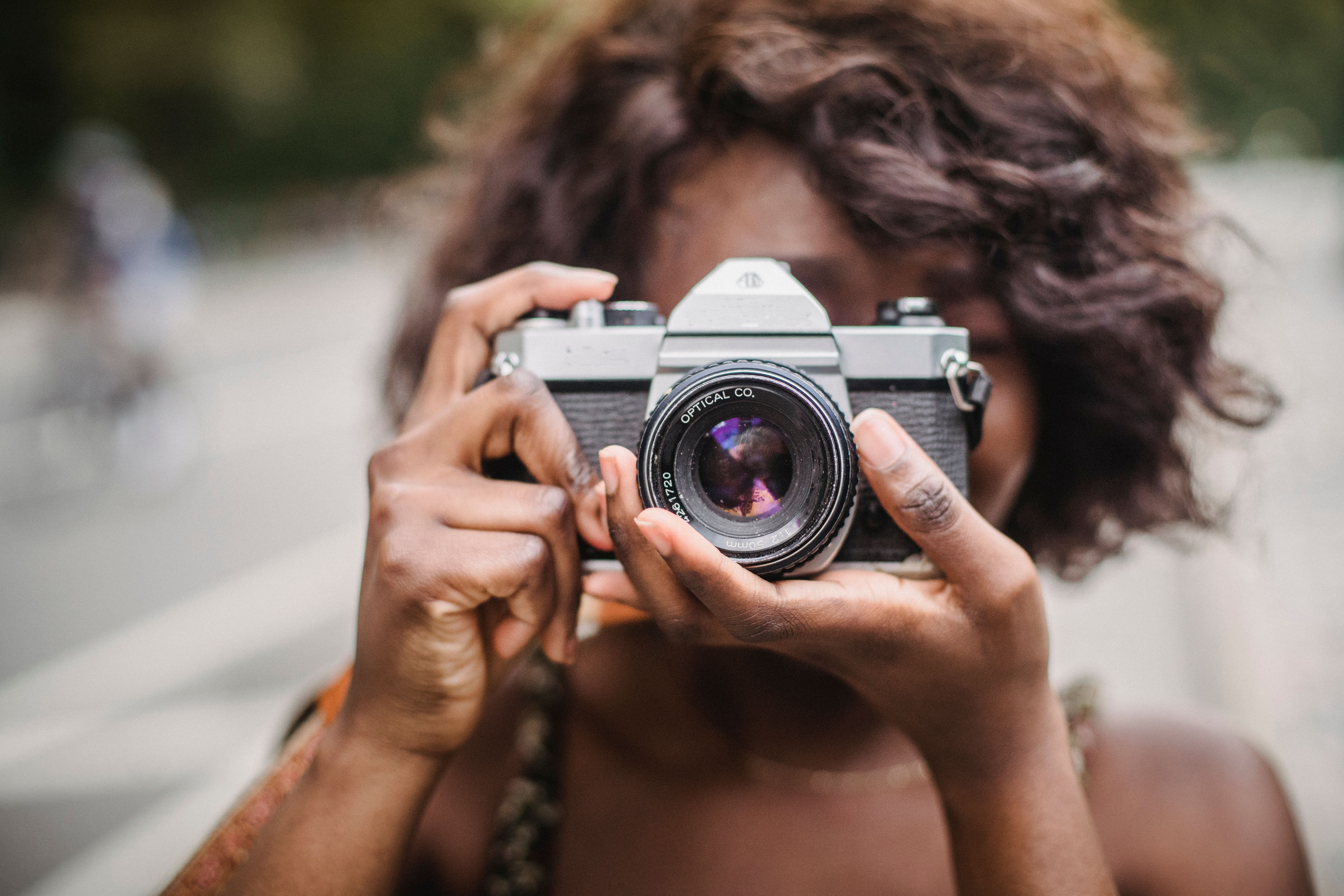 Close-up of a Woman Taking Pictures Using a Camera · Free Stock Photo