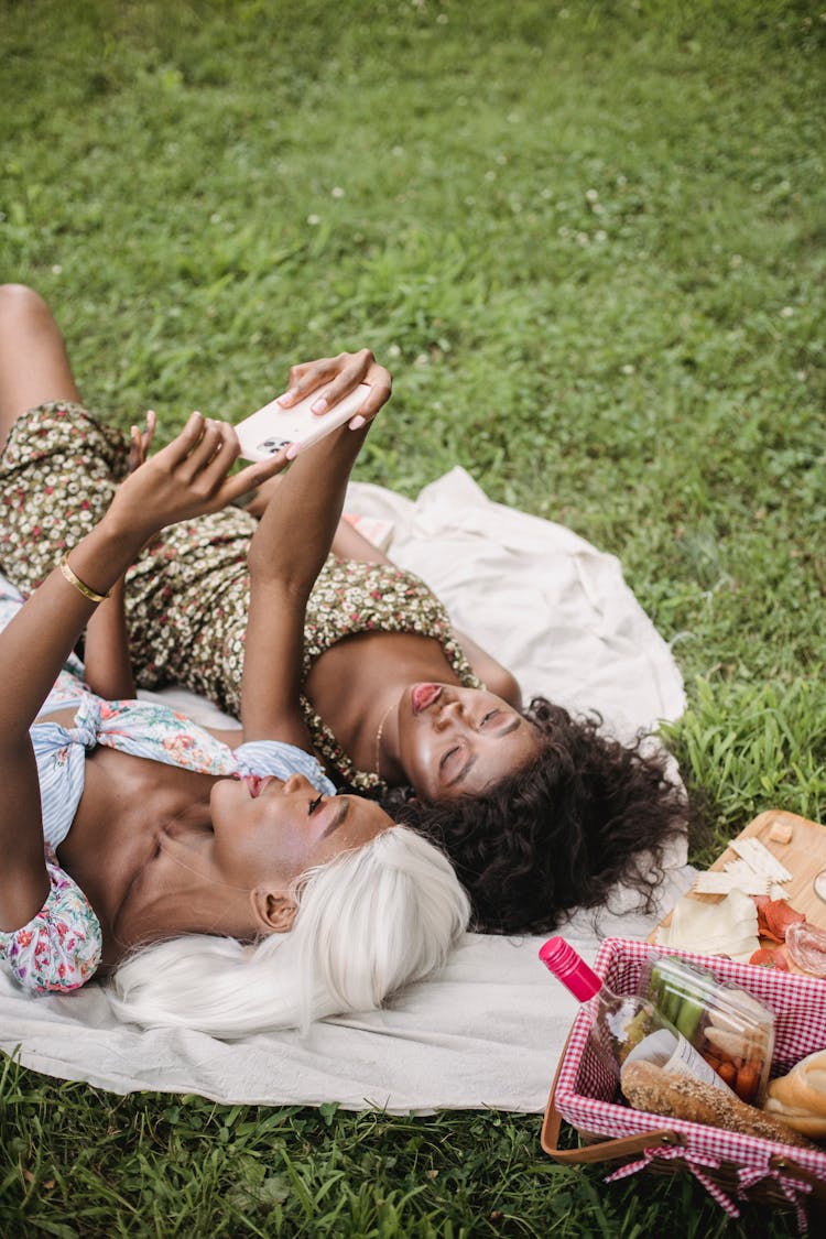 Women In Floral Dresses Taking A Selfie