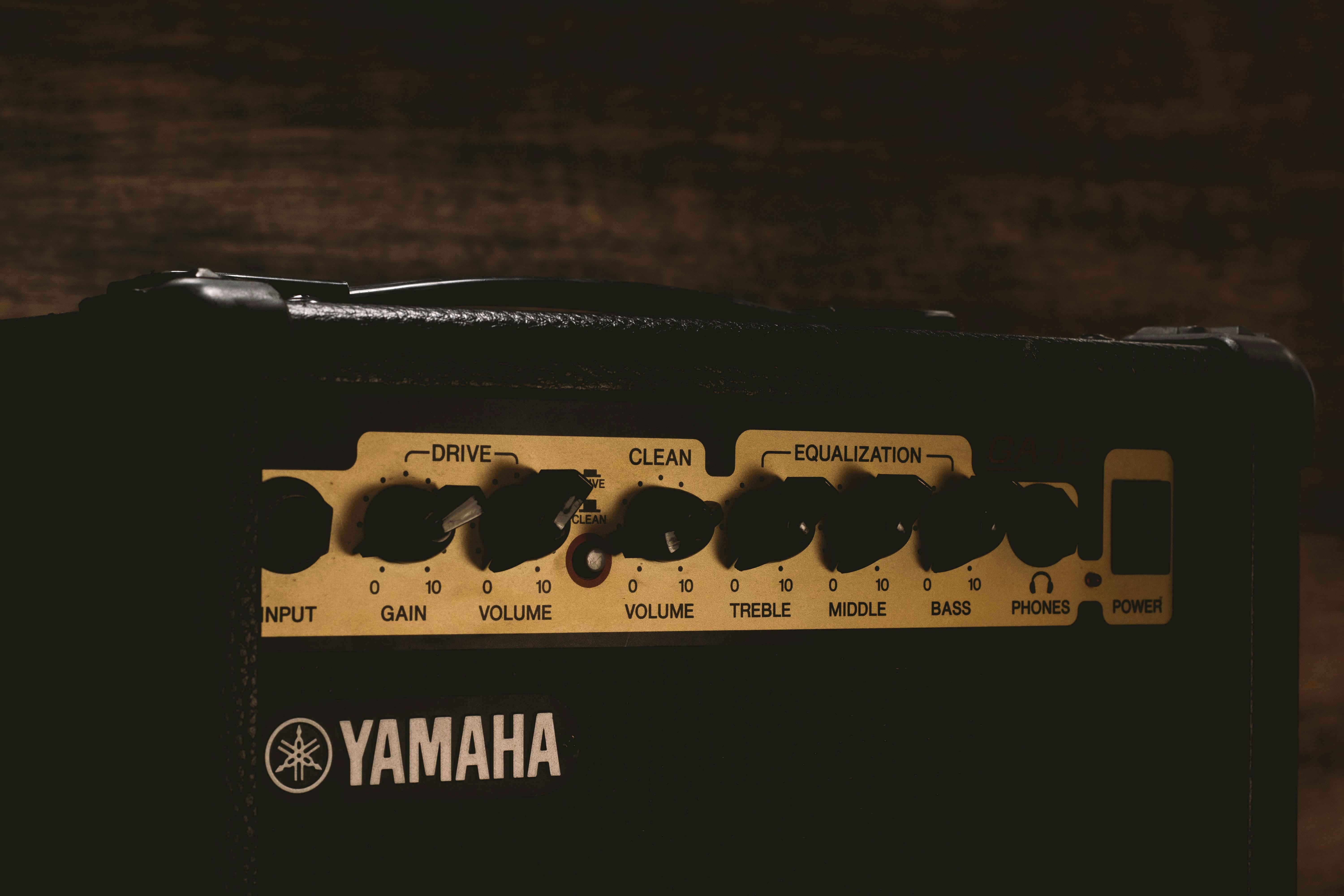Detailed view of a Yamaha amplifier showing control knobs and settings.