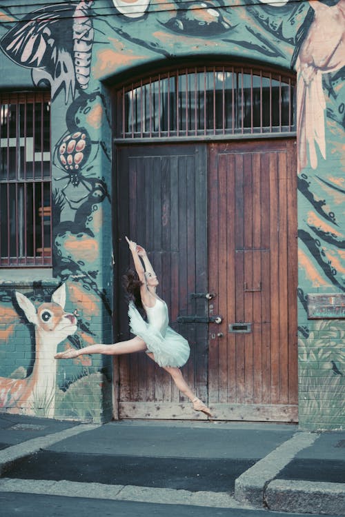 Person Dancing in Front of a Wooden Door