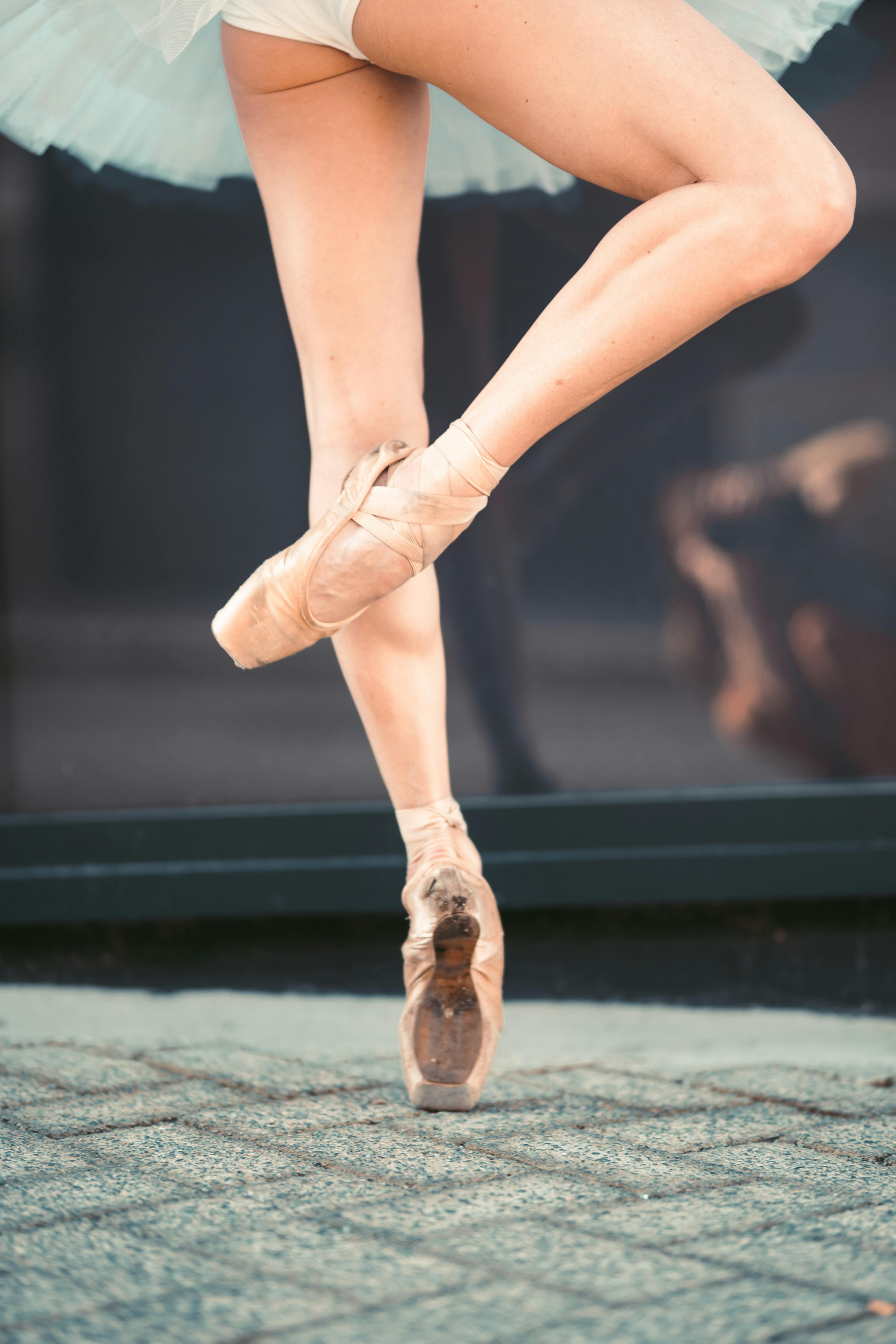 woman wearing ballet shoes dancing