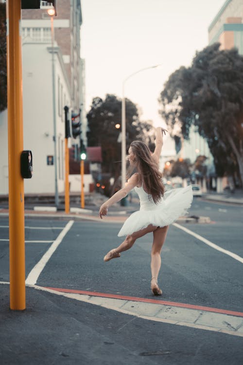 Woman in White Dress Jumping on the Street