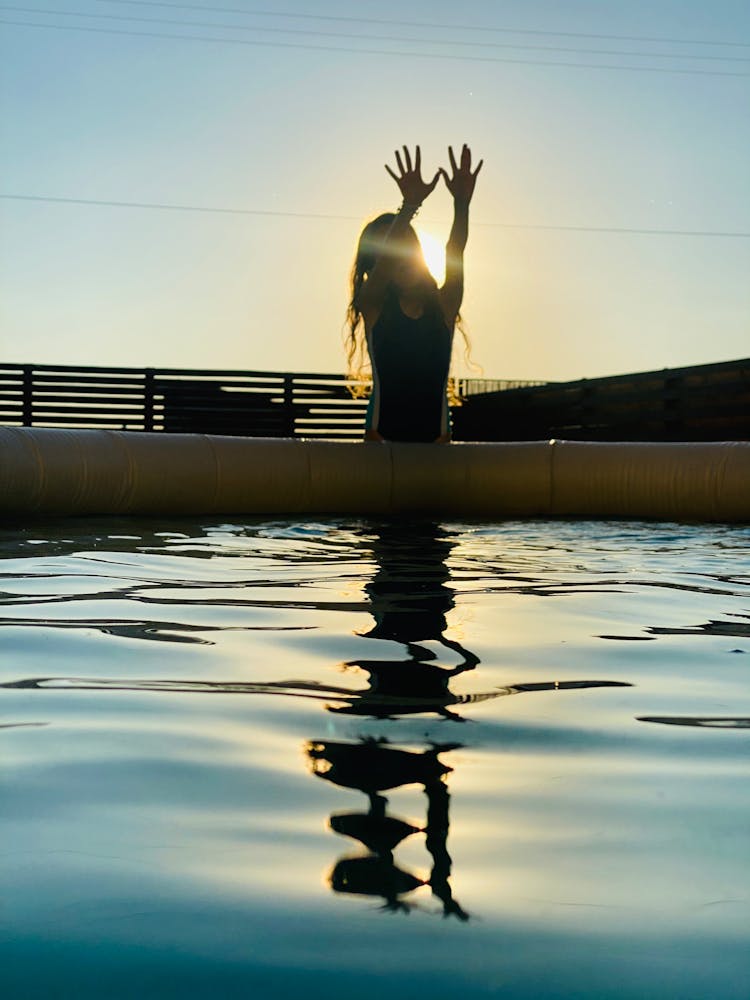 Woman Covering Sun In Swimming Pool