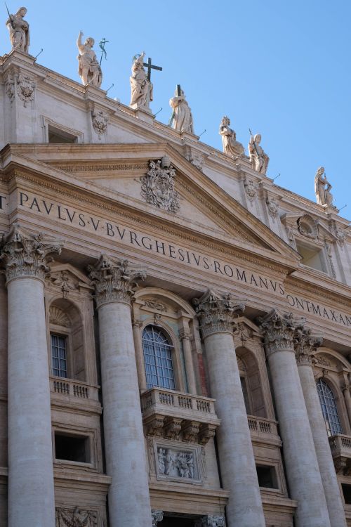 Free Elegant facade of St. Peter's Basilica with statues and columns in Vatican City on a sunny day. Stock Photo