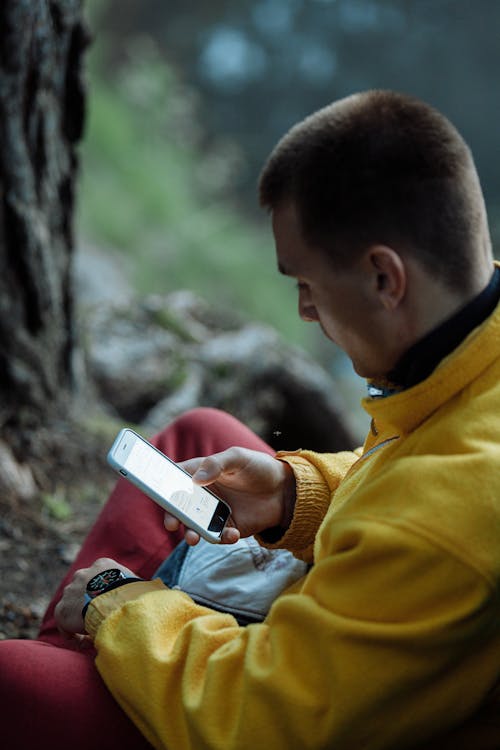 Chłopiec W żółtej Bluzie Trzymający I Phone'a 6